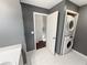 Laundry room with stacked washer and dryer offers convenience with built-in storage space at 1190 Se Village Se Ct, Atlanta, GA 30316