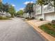 Exterior street view of townhomes, each featuring private garages and landscaped front yards with mature trees at 1190 Se Village Se Ct, Atlanta, GA 30316