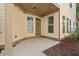 Covered back patio with string lights and neutral color scheme at 7470 Flintlock Way, Alpharetta, GA 30005