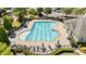 Aerial view of community pool with lounge chairs and a clubhouse at 7470 Flintlock Way, Alpharetta, GA 30005