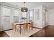 Bright dining room features a modern table, six chairs, and stylish light fixture at 7470 Flintlock Way, Alpharetta, GA 30005