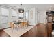 Bright dining room features a modern table, six chairs, and stylish light fixture at 7470 Flintlock Way, Alpharetta, GA 30005