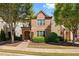 Brick two-story house with landscaping and walkway at 7470 Flintlock Way, Alpharetta, GA 30005