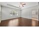 Main bedroom with hardwood floors, ceiling fan, and en-suite bathroom access at 7470 Flintlock Way, Alpharetta, GA 30005