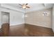 Spacious main bedroom with hardwood floors, tray ceiling, and wall paneling at 7470 Flintlock Way, Alpharetta, GA 30005