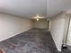 A large basement with dark hardwood floors and neutral walls at 5544 Whispering Swan Ct, Douglasville, GA 30135
