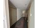 Basement hallway with grey walls and dark laminate floors at 5544 Whispering Swan Ct, Douglasville, GA 30135