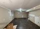 Spacious basement living room with dark floors awaiting finishing touches at 5544 Whispering Swan Ct, Douglasville, GA 30135