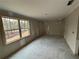 Basement room with large window and concrete floor at 5544 Whispering Swan Ct, Douglasville, GA 30135