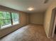Spacious bedroom featuring tan walls, a light and large window providing natural light at 5544 Whispering Swan Ct, Douglasville, GA 30135