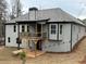 Back exterior featuring a wood deck, gray paint and black trim at 5544 Whispering Swan Ct, Douglasville, GA 30135