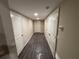 Hallway featuring a wood-style floor, neutral walls, and white trim at 5544 Whispering Swan Ct, Douglasville, GA 30135