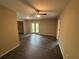 Bright living room features modern hardwood flooring, neutral walls, and glass patio doors for natural light at 5544 Whispering Swan Ct, Douglasville, GA 30135