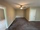 Open-concept living room with dark hardwood floors and neutral walls, illuminated by a ceiling fan and natural light at 5544 Whispering Swan Ct, Douglasville, GA 30135