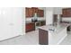 A modern kitchen featuring an island, stainless steel appliances, and wood cabinets at 10922 Wheeler Trce, Hampton, GA 30228