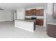 A modern kitchen featuring an island, stainless steel appliances, and wood cabinets at 10922 Wheeler Trce, Hampton, GA 30228