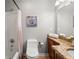 Well-lit bathroom with granite countertop, toilet, and bathtub shower combo at 1937 Brian Way, Decatur, GA 30033