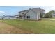 Spacious backyard with lush lawn, covered patio, and view of the home at 63 Youth Jersey Rd, Covington, GA 30014