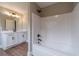Bathroom with tub shower, white cabinets, modern finishes, and a view into another bathroom at 63 Youth Jersey Rd, Covington, GA 30014