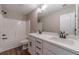 Bathroom with tub shower, double vanity, white cabinets, quartz countertops, and modern finishes at 63 Youth Jersey Rd, Covington, GA 30014