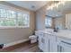 Bathroom features a large window and a vanity with shaker cabinets and quartz countertops at 63 Youth Jersey Rd, Covington, GA 30014