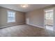 Bedroom with a window and natural light showcasing neutral walls, and plush carpeting at 63 Youth Jersey Rd, Covington, GA 30014