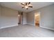 Neutral bedroom with carpet, ceiling fan, and adjacent bath and hallway entrances at 63 Youth Jersey Rd, Covington, GA 30014