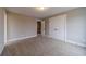 Bedroom features neutral walls, carpet, and a view of the hallway through a doorway at 63 Youth Jersey Rd, Covington, GA 30014