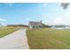Charming new construction home featuring a covered porch and spacious front lawn at 63 Youth Jersey Rd, Covington, GA 30014