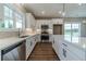 Bright kitchen with white cabinets, stainless steel appliances, and an island featuring a smooth, white countertop at 63 Youth Jersey Rd, Covington, GA 30014