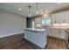 Open kitchen with a large island, pendant lighting, and stainless steel appliances at 63 Youth Jersey Rd, Covington, GA 30014