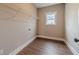 Convenient laundry room with wire shelving and hardwood floors at 63 Youth Jersey Rd, Covington, GA 30014