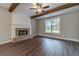 Bright living room with a brick fireplace, wood floors, and natural light at 63 Youth Jersey Rd, Covington, GA 30014