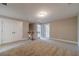 Open loft area with neutral walls, carpet, and a view of doorways leading to other rooms at 63 Youth Jersey Rd, Covington, GA 30014