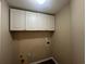 Bright laundry room with white cabinets and vinyl flooring at 1824 Thornhill Se Pass, Conyers, GA 30013