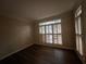 Bright living room with plantation shutters and hardwood floors at 1824 Thornhill Se Pass, Conyers, GA 30013