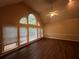 Sunlit living room with hardwood floors and a wall of windows at 1824 Thornhill Se Pass, Conyers, GA 30013