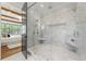 Luxurious bathroom featuring a glass shower and upscale marble tiling with bench seats at 11 Brownson Ct, Acworth, GA 30101