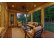 Relaxing covered porch with comfortable seating and a serene view of the lush backyard at twilight at 11 Brownson Ct, Acworth, GA 30101
