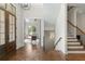 Grand foyer with herringbone floors, chandelier, and staircase leads to a naturally lit office at 11 Brownson Ct, Acworth, GA 30101