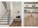 Stylish hallway features detailed stair railing, accent bench, and custom built-in shelving at 11 Brownson Ct, Acworth, GA 30101