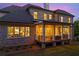 Elegant home with a covered porch and a well-maintained lawn at twilight at 11 Brownson Ct, Acworth, GA 30101