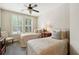 Charming bedroom with twin beds, window with shutters, and ceiling fan at 901 Abernathy Ne Rd # 2050, Sandy Springs, GA 30328