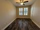 Bright bedroom featuring wood-look floors and window shutters at 901 Abernathy Ne Rd # 2050, Sandy Springs, GA 30328