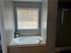 Inviting soaking tub in a serene bathroom, perfect for a relaxing retreat at 989 Park Knoll Ct, Lawrenceville, GA 30043