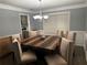 Dining room with an elegant chandelier and large, wooden table at 989 Park Knoll Ct, Lawrenceville, GA 30043