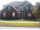 Charming two-story brick home featuring manicured landscaping and a welcoming facade at 989 Park Knoll Ct, Lawrenceville, GA 30043