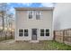 The back of the home has a fence-enclosed backyard with two stories and a door entrance at 5100 Windsor Forrest Ln, Atlanta, GA 30349