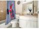 This small bathroom features a vanity, toilet and tub with tiled shower at 5100 Windsor Forrest Ln, Atlanta, GA 30349