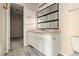 This bathroom features a vanity, mirror, and walk in closet at 5100 Windsor Forrest Ln, Atlanta, GA 30349